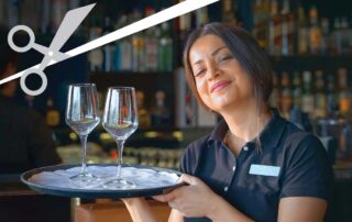 A waitress holding sparkling wine glasses.